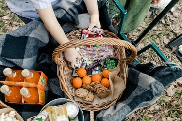 Kids' hands reaching into wagon for snacks