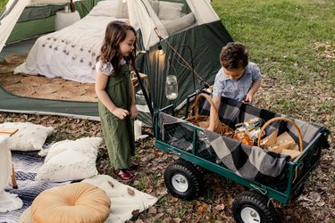 Two kids getting snacks out of the concession wagon