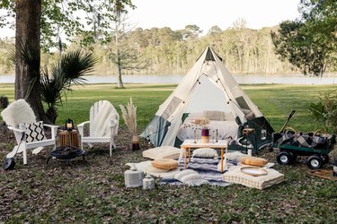 DIY backyard glamping tent with fire pit and lounge area