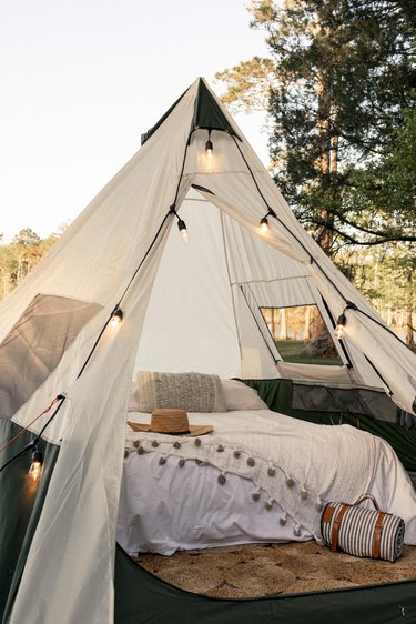 String lights strung around front entrance of tent