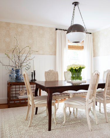 Cream and white dining room with globe-shaped traditional dining room lighting