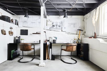 industrial basement office with leather chairs and white walls