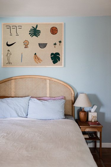 blue and beige desert house color palette in bedroom with rattan bedframe and wall hanging