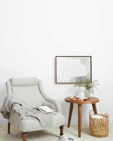 sofa chair near wood table and framed artwork
