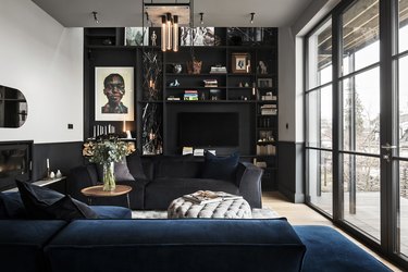 black living room with blue sectional sofa