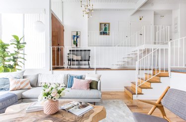 Light gray couch with silver and white rug