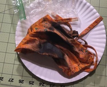 burnt cloth face mask that has been microwaved