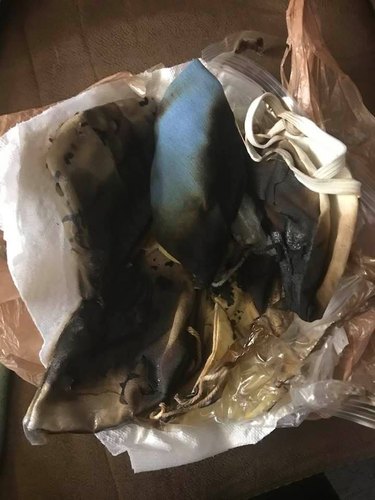 burnt blue cloth face mask that has been microwaved