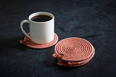 coffee on coaster and stack of coasters nearby