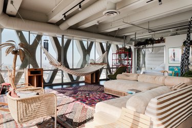 modern apartment with floor to ceiling windows and white sofa