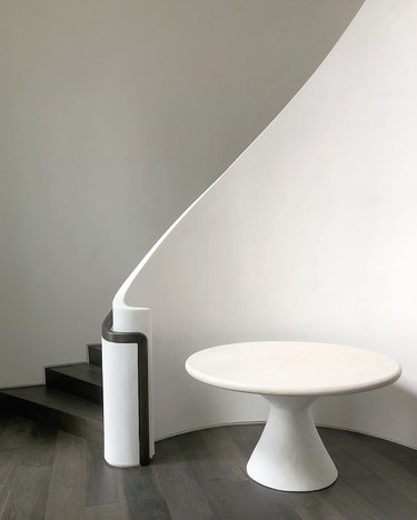 solid poured plaster banister with black stair railing