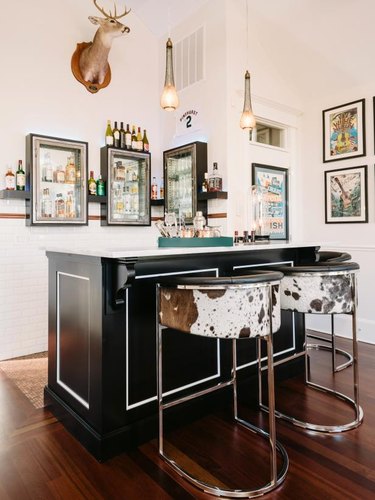 black basement bar with class wall cabinets and wall art