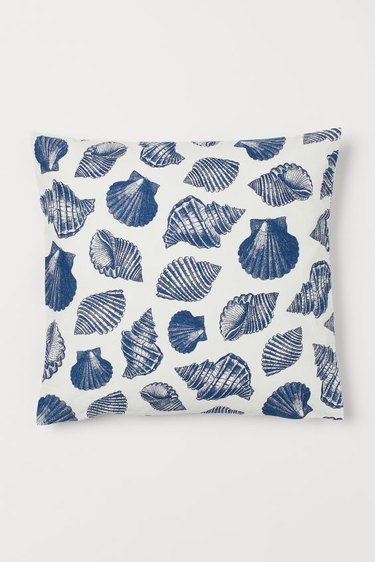 blue and white pillow with sea shell pattern