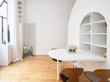 half-circle fold-out dining table in all-white living room