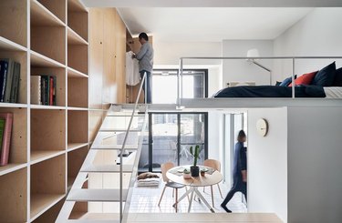 split-level apartment with modular bookcase and lofted bedroom
