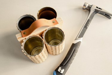 Leather strap attached to wood board with brass tacks and HART hammer