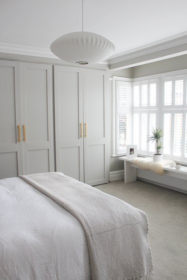 Clutter-free white bedroom with built in storage