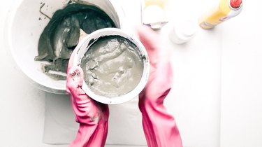 Agitating concrete in mold to release trapped air.