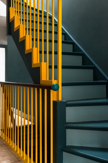 painted stairs with yellow handrail teal steps