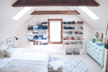 A-frame bedroom shelving idea with open shelving for clothes and shoe storage