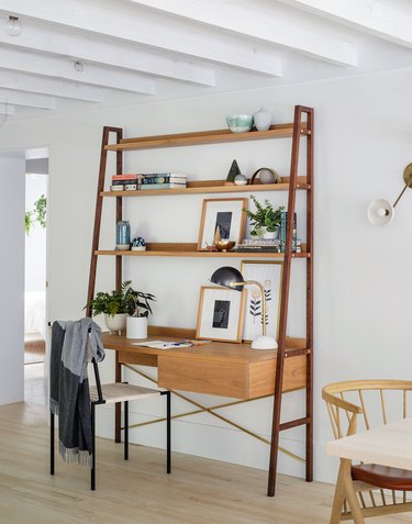 Scandinavia home office setup that includes a singular unit of a desk with shelving