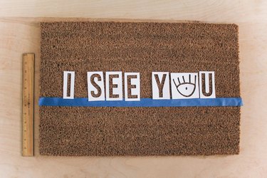 Letter stencils centered on doormat