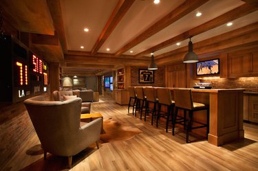 basement man cave ideas with exposed wood beams and bar