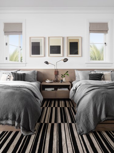 black and white bedroom idea with striped carpet and single nightstand