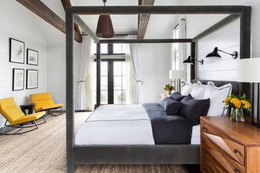 black and white bedroom idea velvet canopy bed and exposed ceiling beams