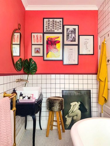bathroom design idea with bright pink walls and vintage sink cabinets