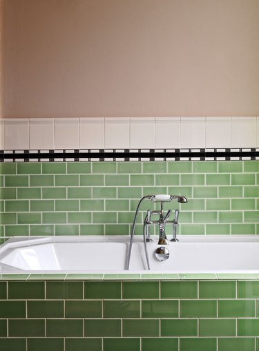 bathroom design idea with pink and green vintage tiles with silver taps