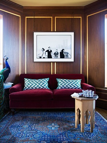 living room sofa ideas with wood paneling on the walls and velvet sofa