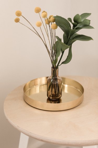 brass metal tray with glass vase holding billy balls