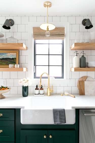 kitchen backsplash idea with white subway tile and open shelving and green cabinets