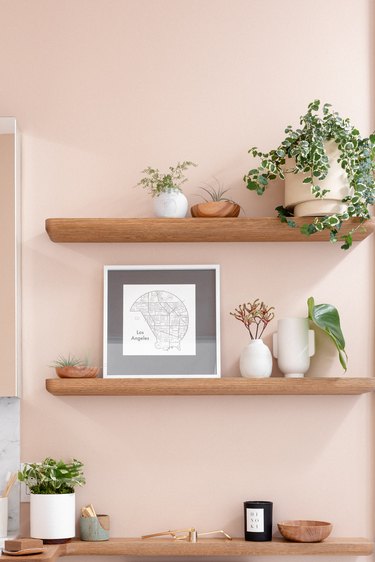 bathroom shelves on a light pink/salmon wall