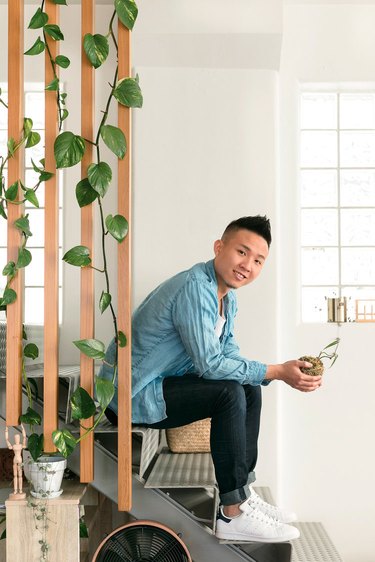 Ron Goh sitting on stairs in loft