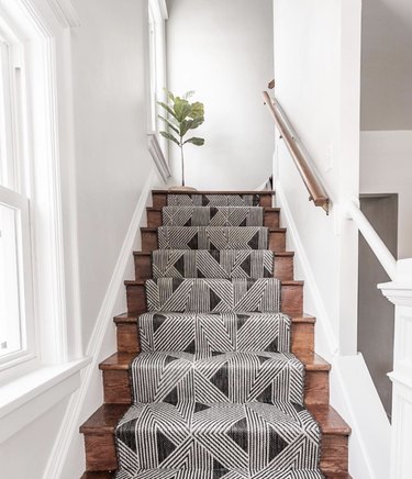 Boho geometric stair runners with fiddle leaf fig tree on dar wook stairs
