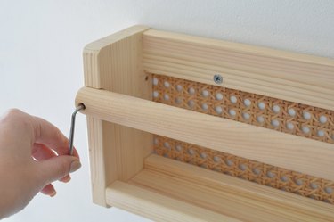 Screwing cane shelf to wall