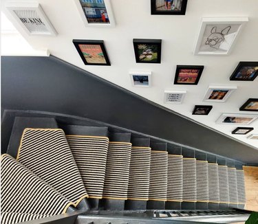 Small-striped stair runners on gray stairs with gallery wall