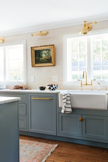 Traditional kitchen design with antique painting and blue cabinets