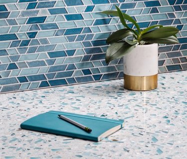 Blue and white speckled quartz countertop colors, blue shades glass backsplash tile.