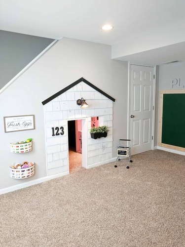 Basement Playroom Ideas with playhouse and chalkboard