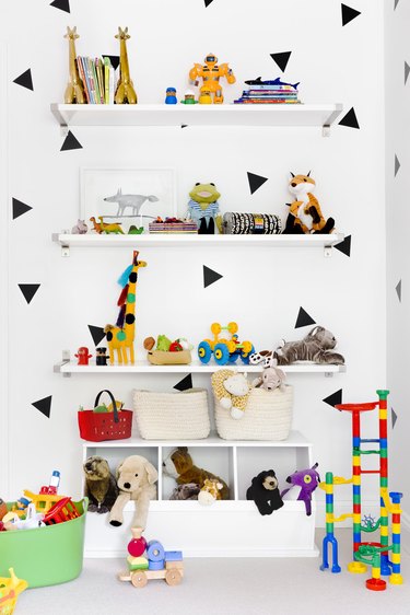 Basement Playroom Ideas with wall decals and wall shelves