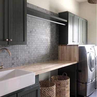 basement laundry room ideas with washer and dryer and green cupboards.