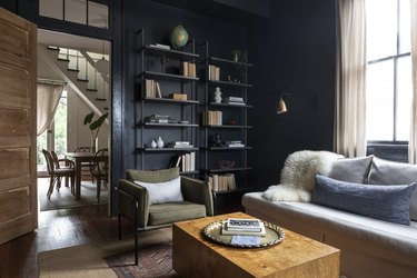 black neutral colors in living room with gray couch and green accent chair