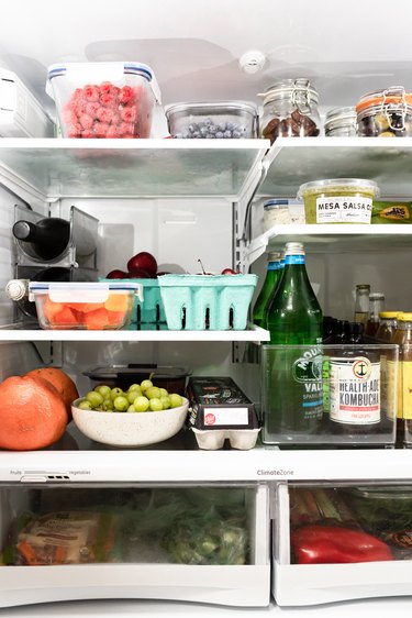 the inside of a refrigerator filled with fresh produce and other groceries