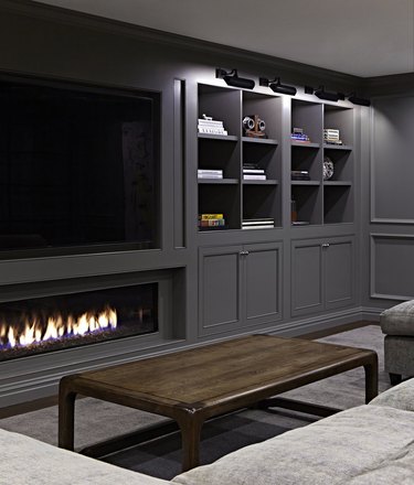 gray basement paint colors in basement with fireplace and mounted TV