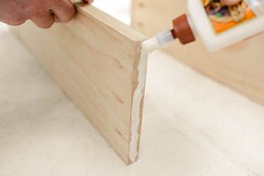Adding wood glue to the end of wood board