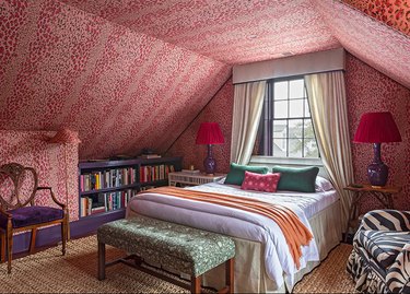 maximalist bedroom with red leopard print walls and ceiling