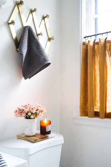 mustard-yellow bathroom curtain idea with cafe curtain in a bathroom window